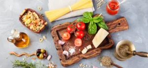 Fresh Italian ingredients including pasta, tomatoes, basil, olive oil, and cheese — essentials for authentic Italian food in Singapore.