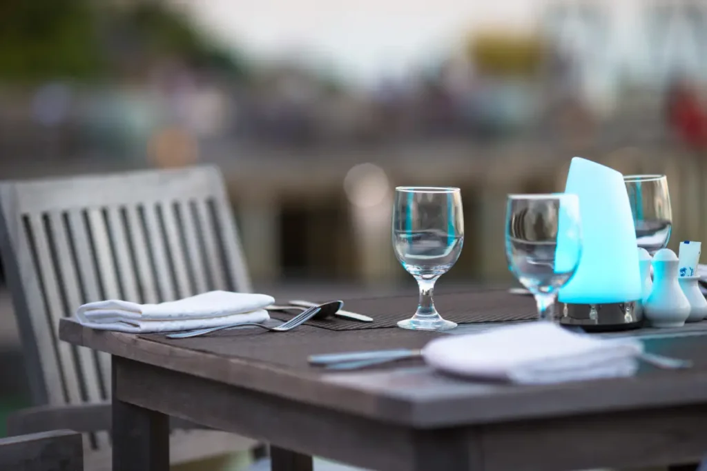 An outdoor table with the usual table setup for alfresco dining in Singapore.
