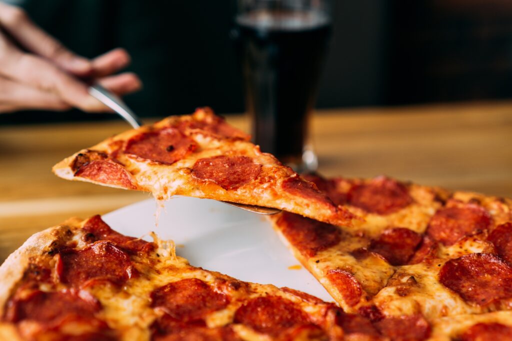 New York Style Pizza sliced, showing thin crust