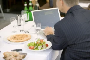 Professional enjoying an Italian set lunch while working on a laptop in a restaurant setting.